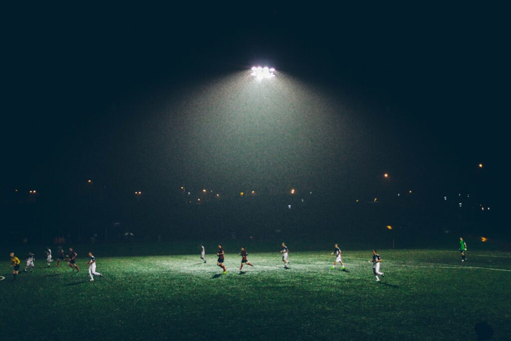 Football match action on a green pitch - football streaming