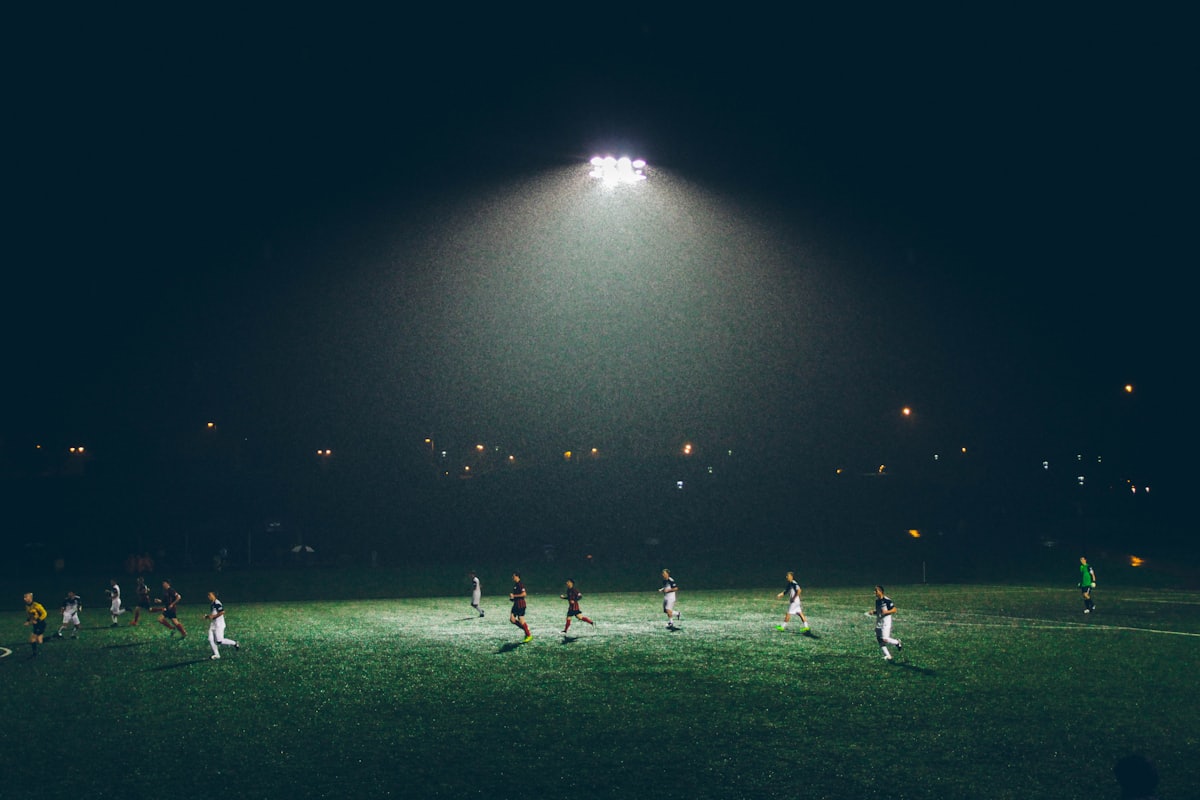 Football match action on a green pitch