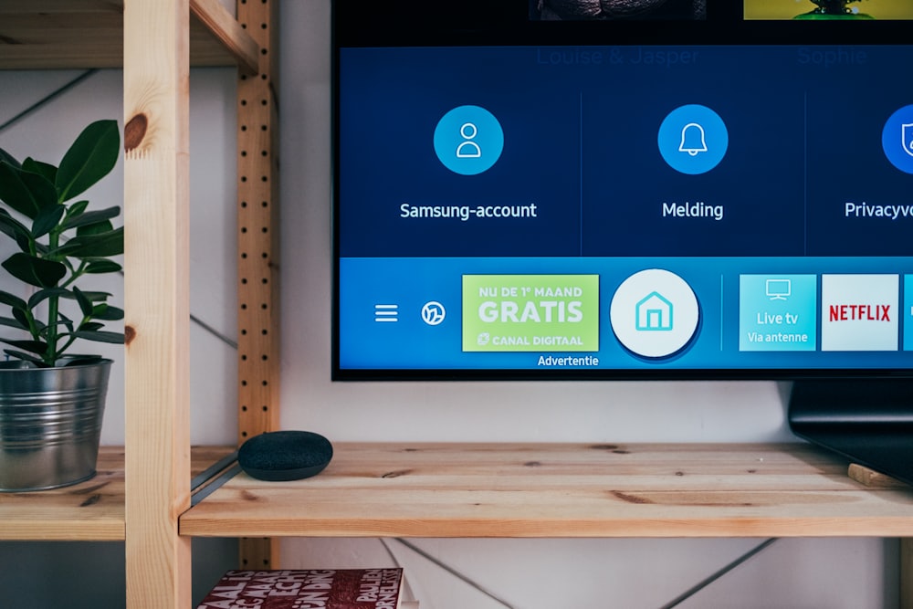 Person holding a remote in front of a modern television - IPTV subscription