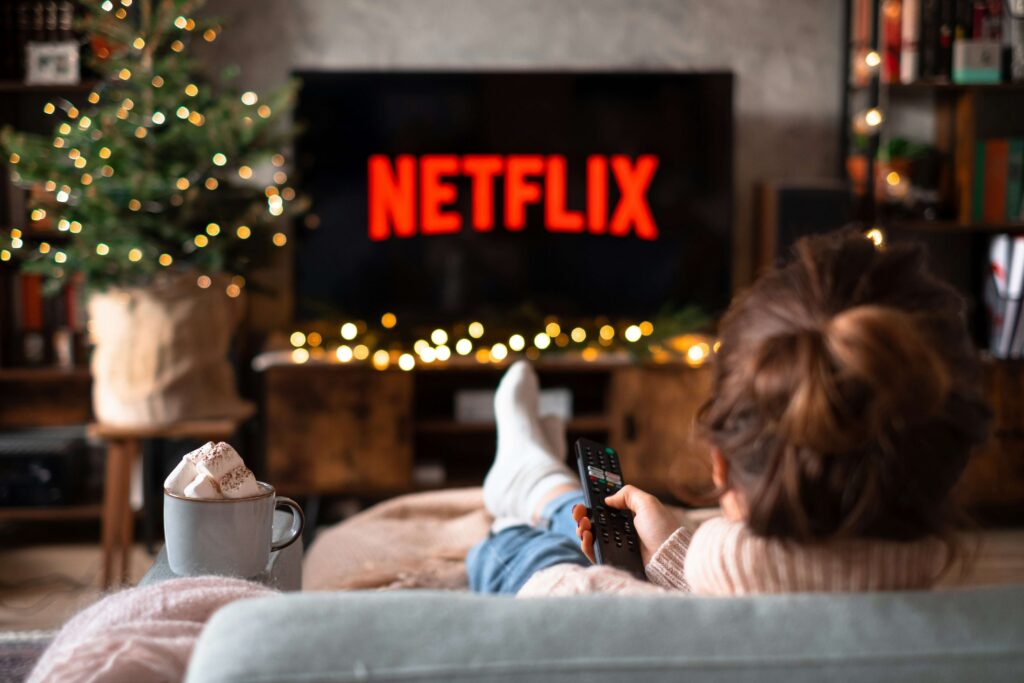 Smart TV screen glowing in a dark home theater streaming setup